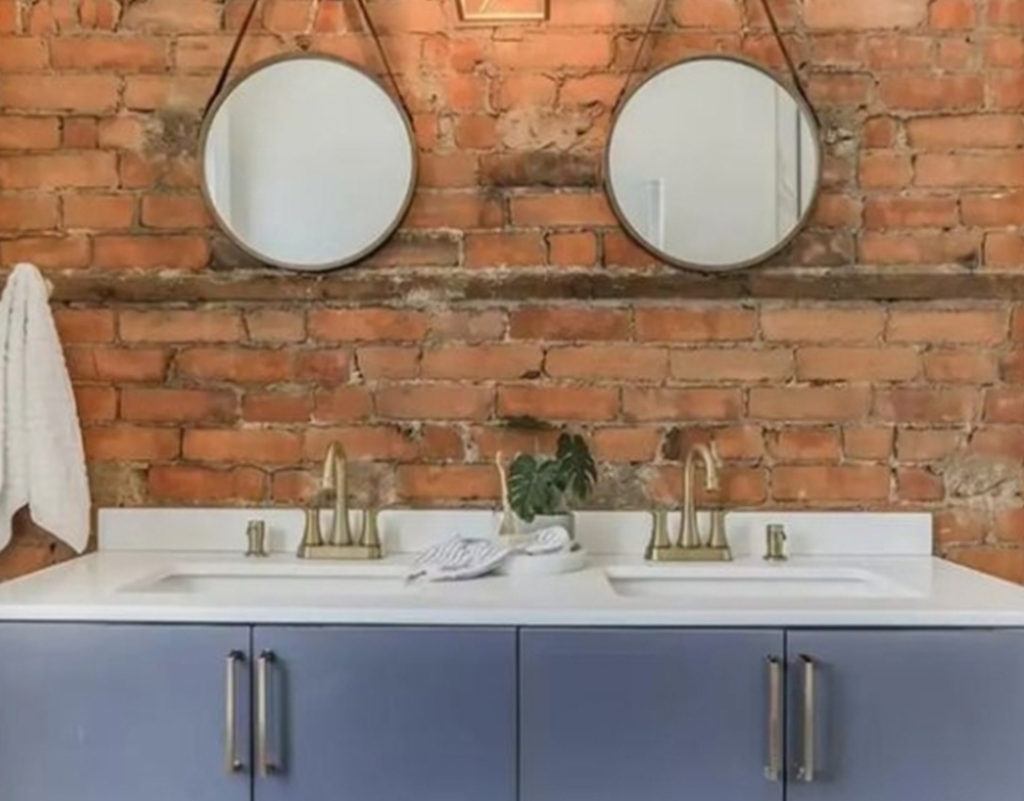 double sinks in a vanity with two circle mirrors