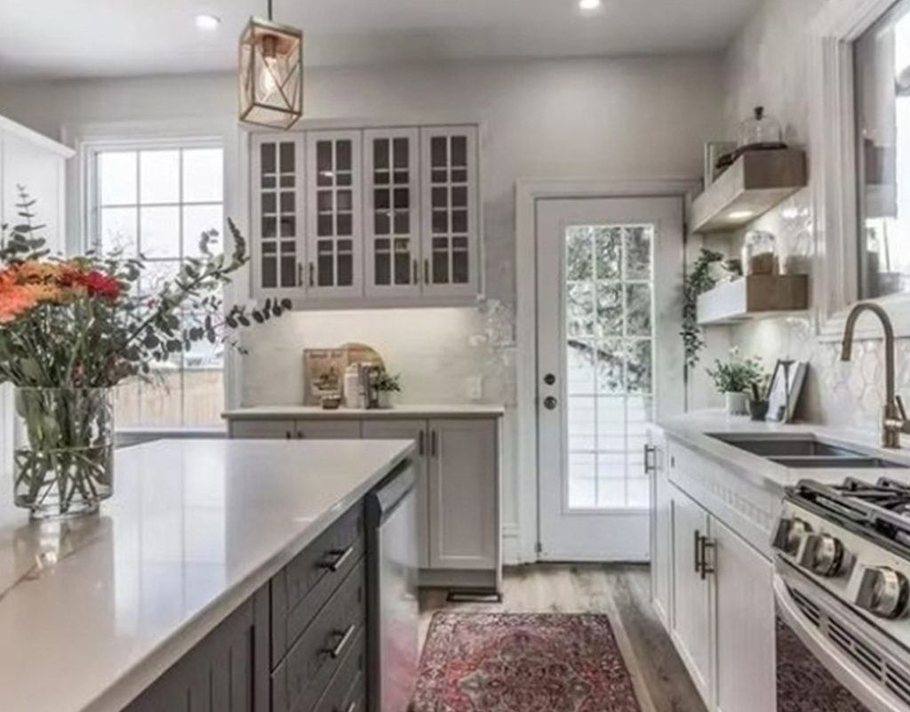 flowers in a vase on a kitchen island with a white countertop