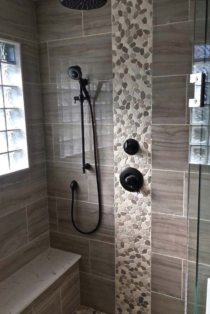 close up photo of a shower with detailed tiling