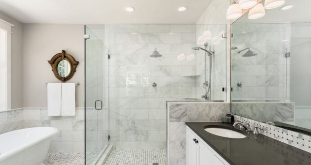 a bathroom with a white soaker tub and glass shower