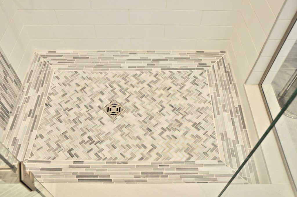 close up photo of the tiling of a shower floor