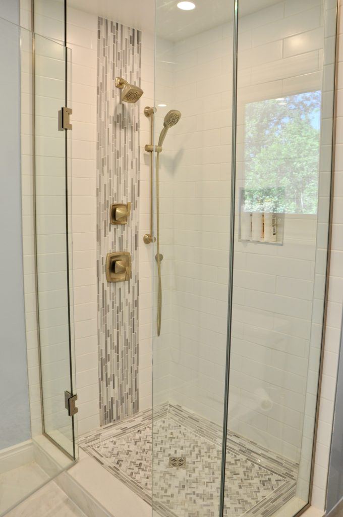 a tiled shower with glass doors