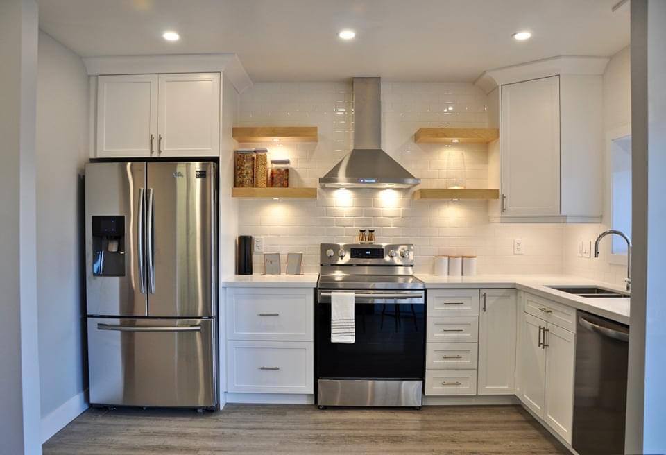 remodelled kitchen with stainless steel appliances and white cabinetry