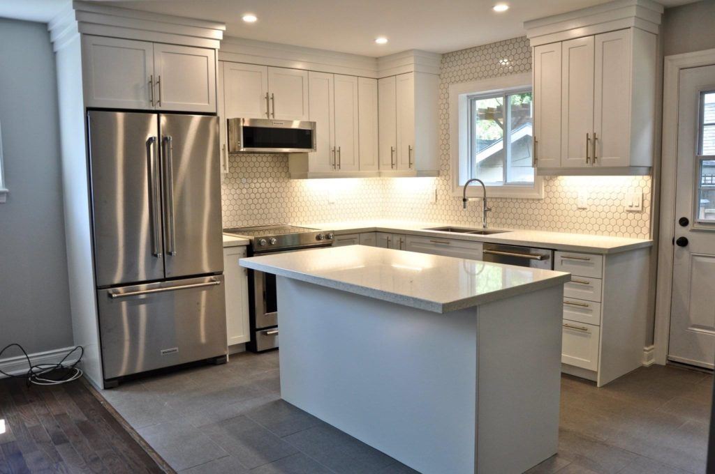 remodelled kitchen with white countertops and grey and white cabinetry