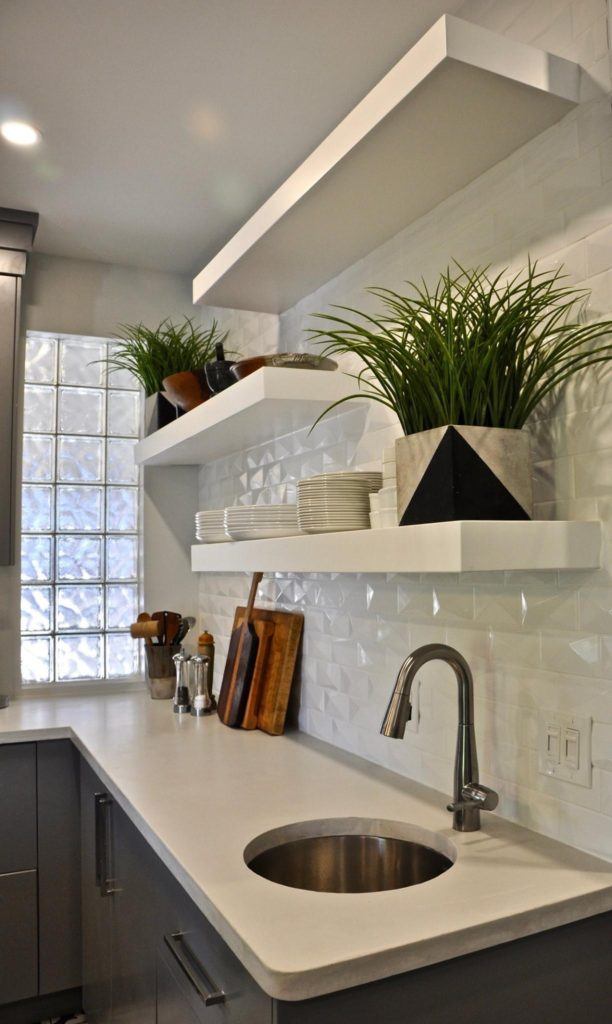 white shelves with plants on a kitchen wall
