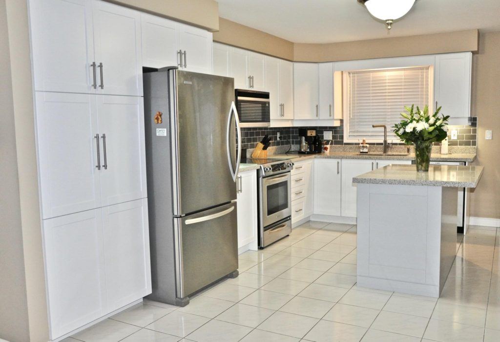 kitchen with white tiled floors and white cabinetry