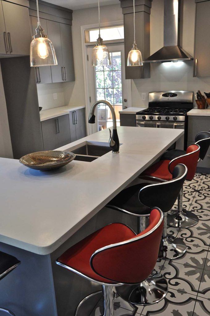 red and black bar stools pulled up to a kitchen countertop