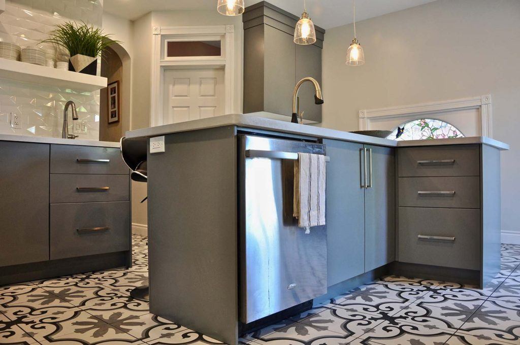 stainless steel dishwasher in a remodelled kitchen with grey cabinetry