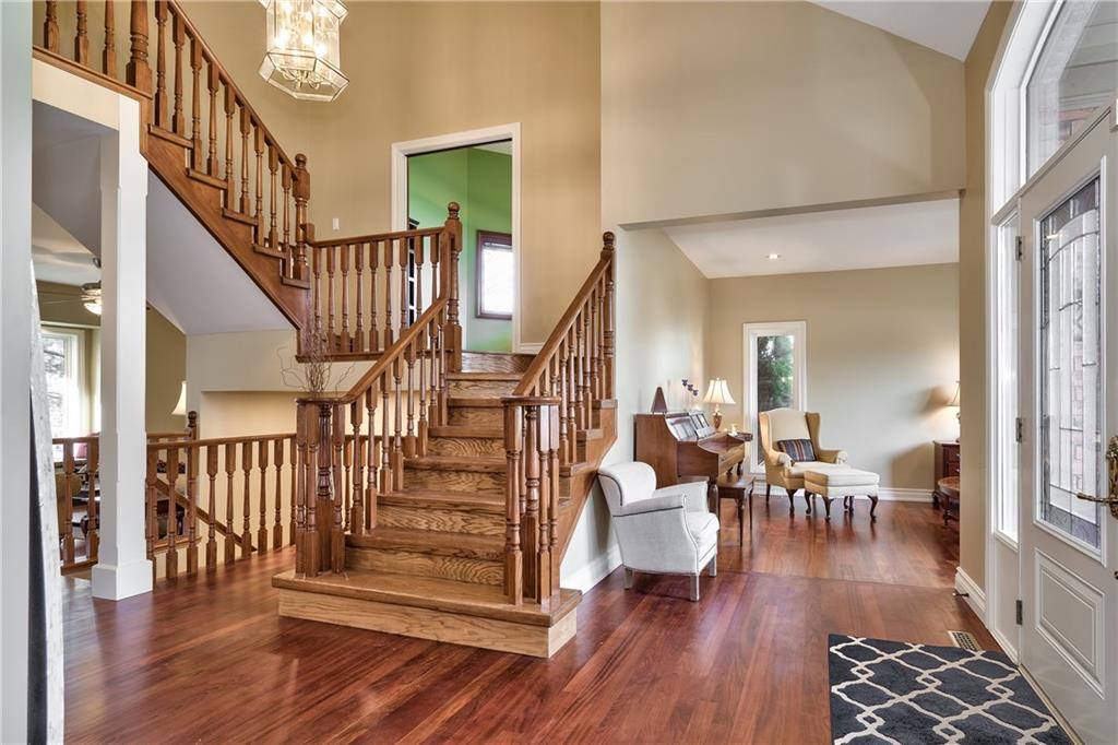 living room with hardwood floor and a staircase