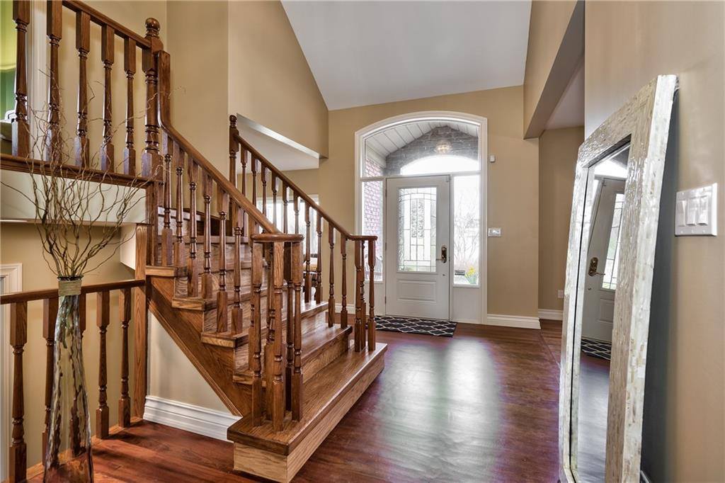 home entryway with hardwood floor and a wood staircase