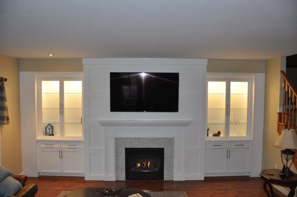 flatscreen television above a mantle and fireplace